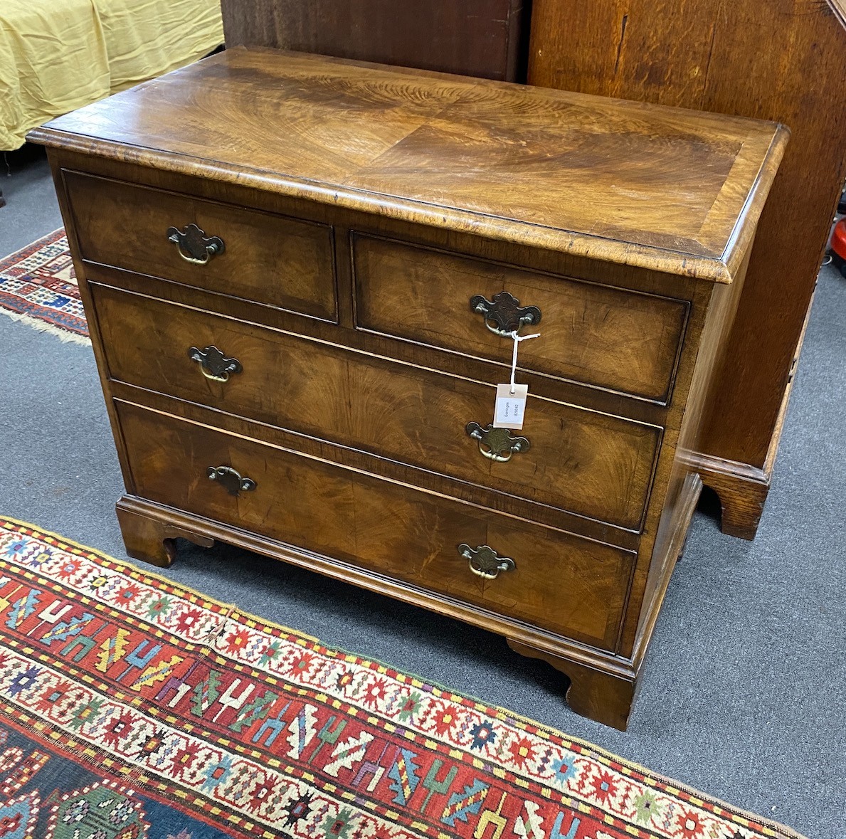 A Queen Anne revival banded walnut chest of two short and two long drawers, width 88cm, depth 46cm, height 74cm